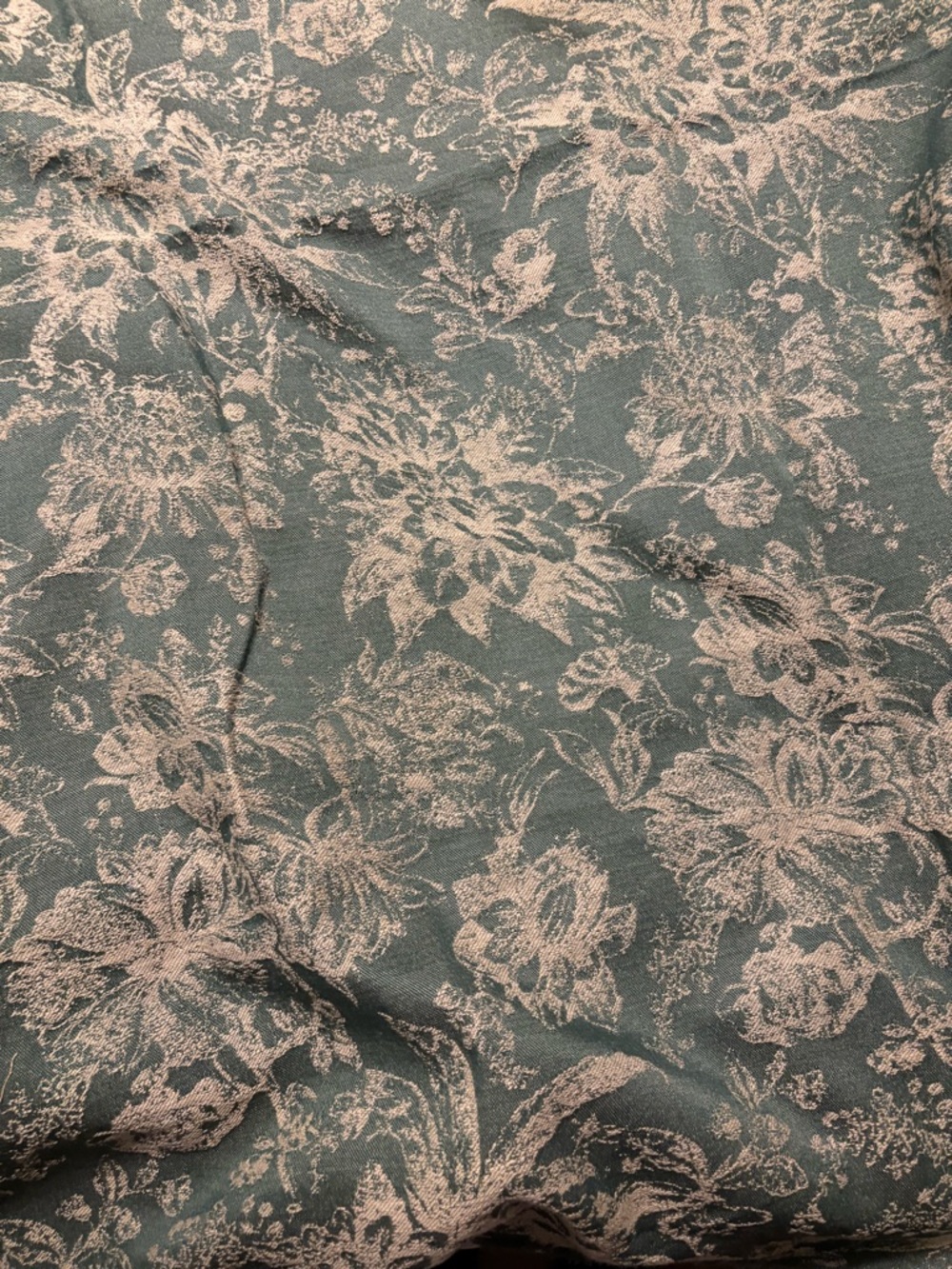 Jacquard weave floral moss green fabric. Flowers appear beige color.